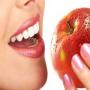 Women article foods making white and shiny teeth